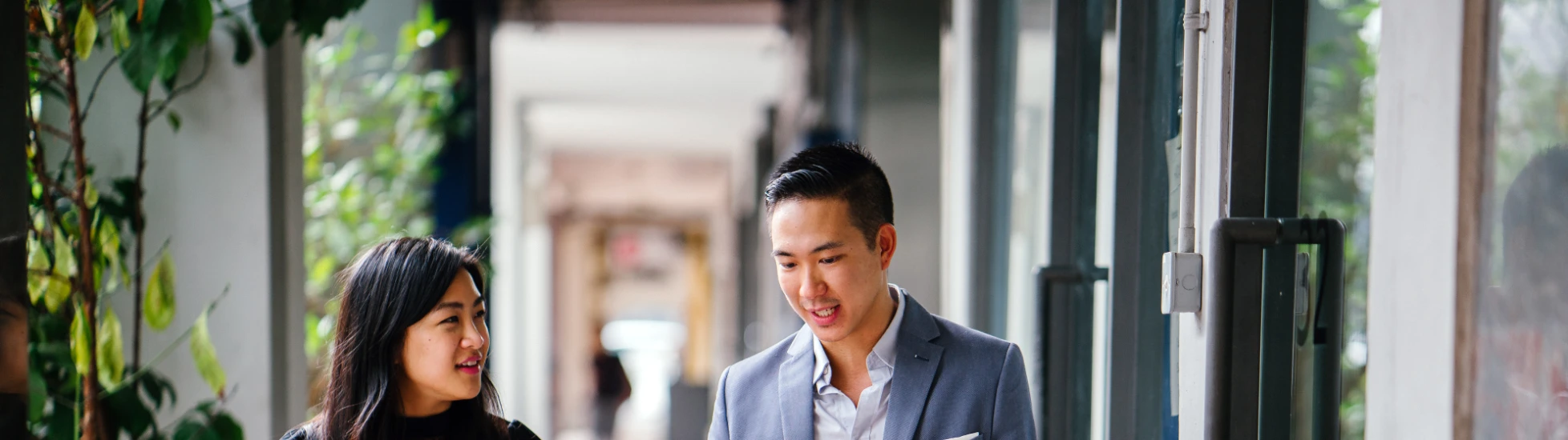 Two Professional Business People Walking