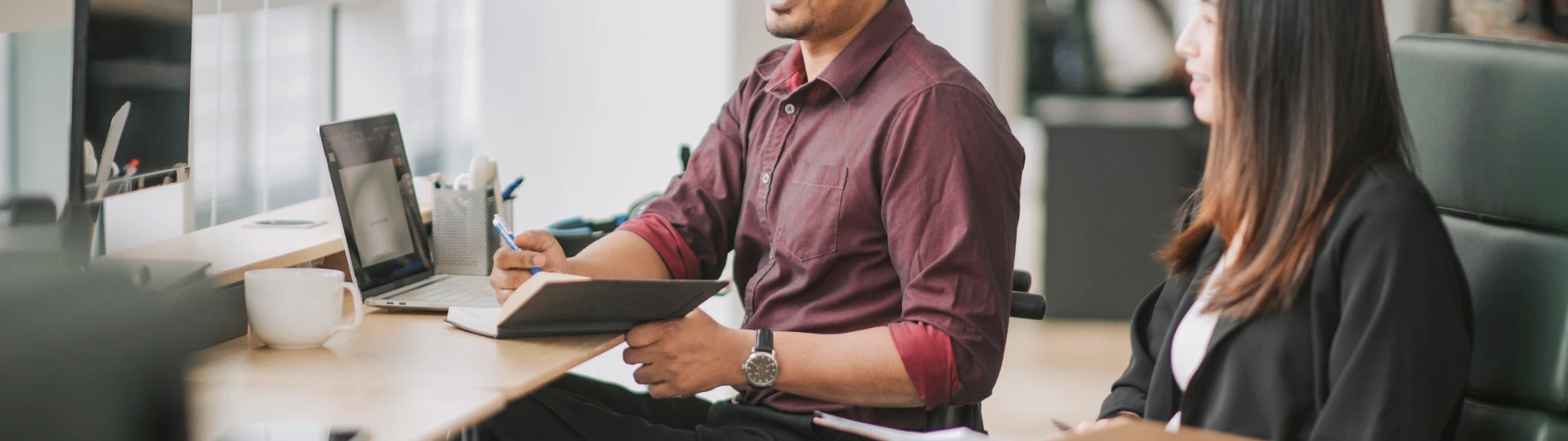 disabled man having a meeting with a woman colleague