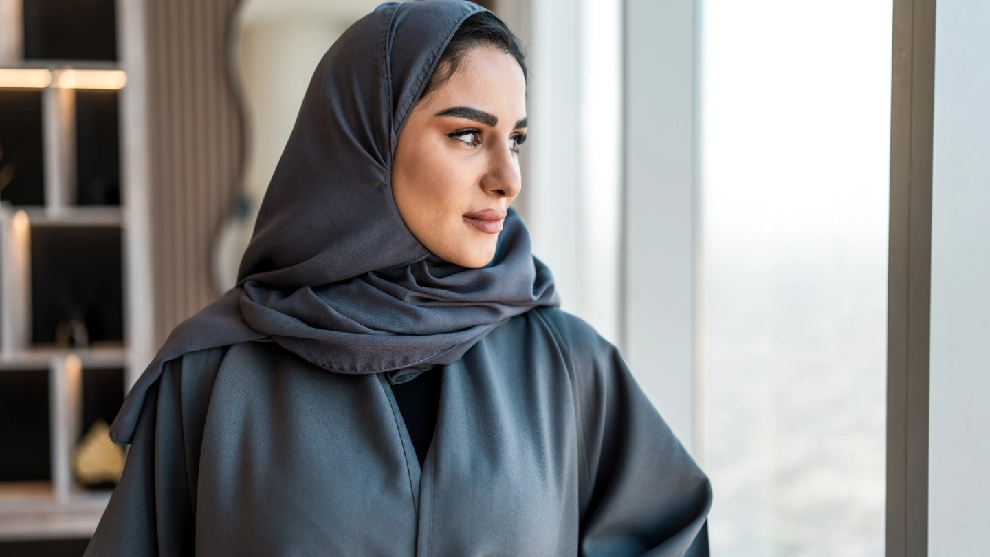 Arabic woman looking out of a window image