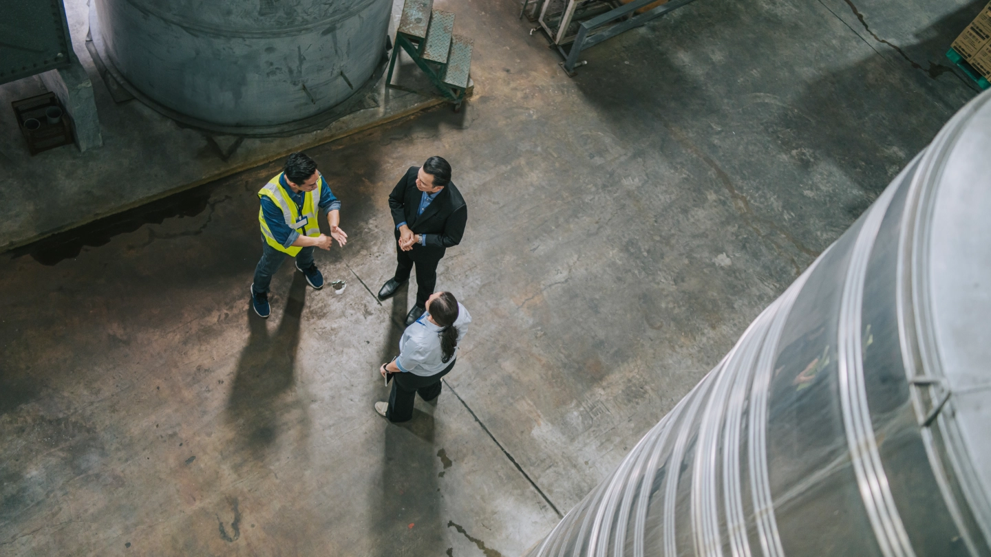 Workers having a discussion in a large warehouse image