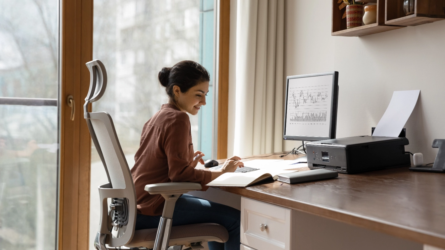 woman behind desk working on computer
